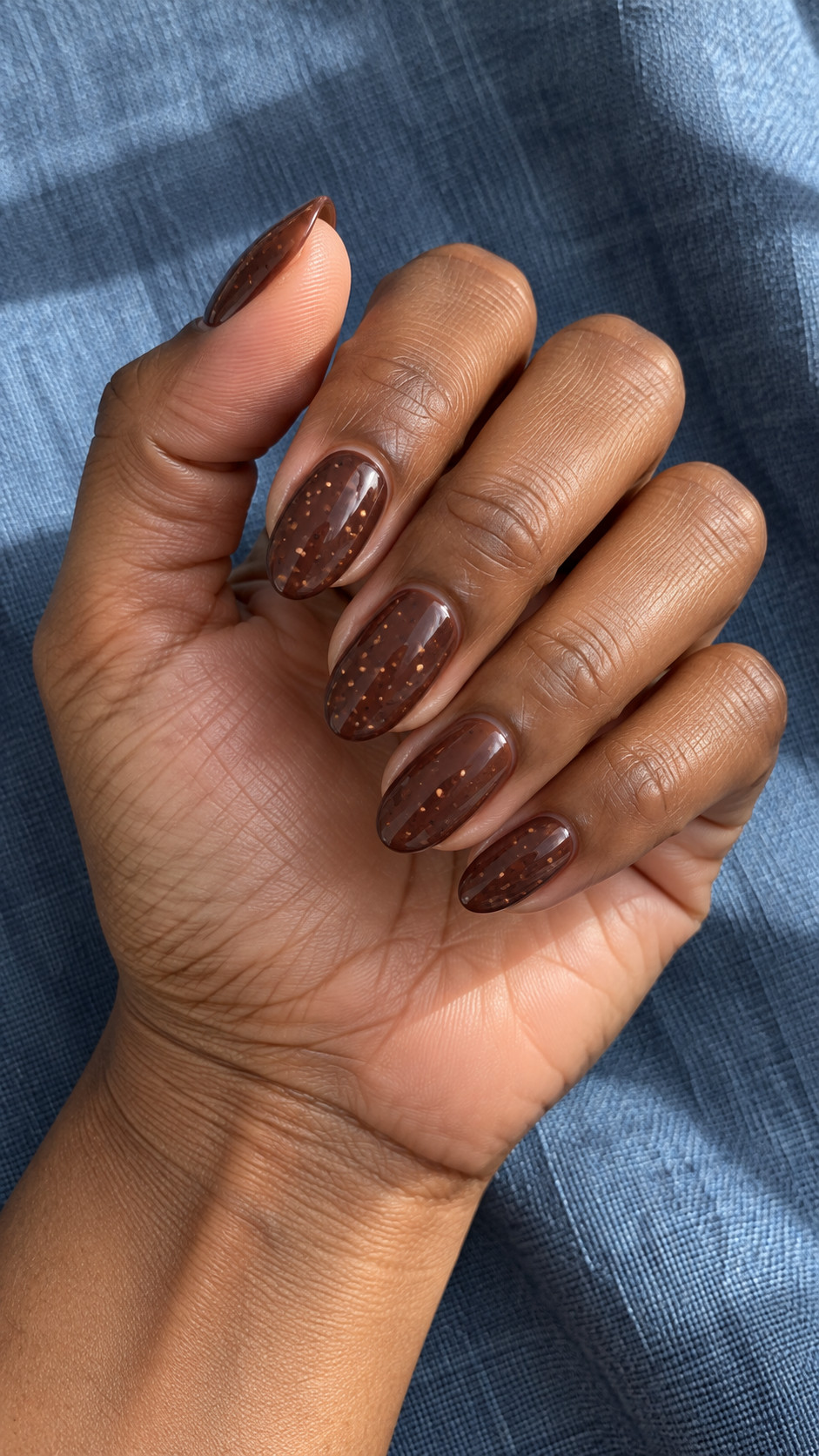 Chocolate Brown Nails idea 11: Cacao Speckles manicure on a realistic feminine hand