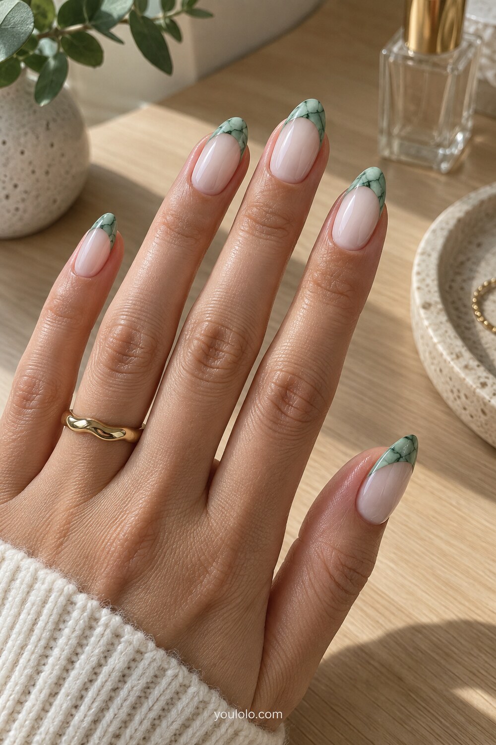 Celadon green side-tip French manicure with a sheer nude base