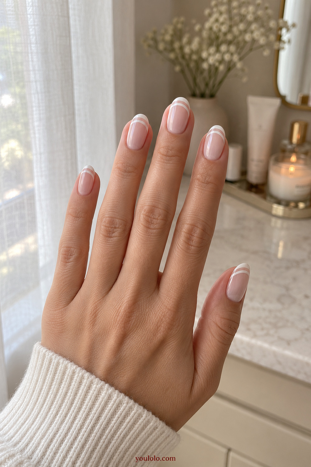 Double white French lines over a translucent milky manicure