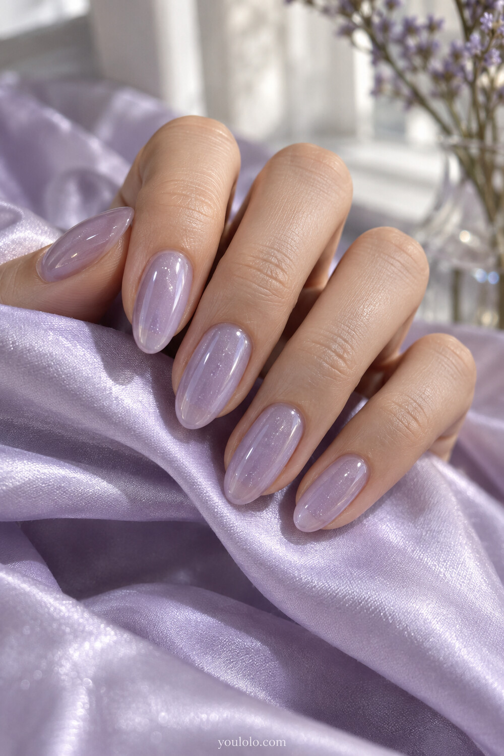 Lavender Korean jelly nails with fine shimmer suspended beneath the tint