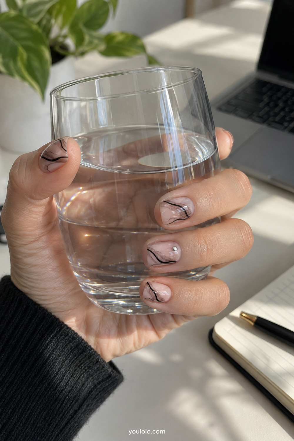 Translucent nude short nails with abstract black smoke swirls
