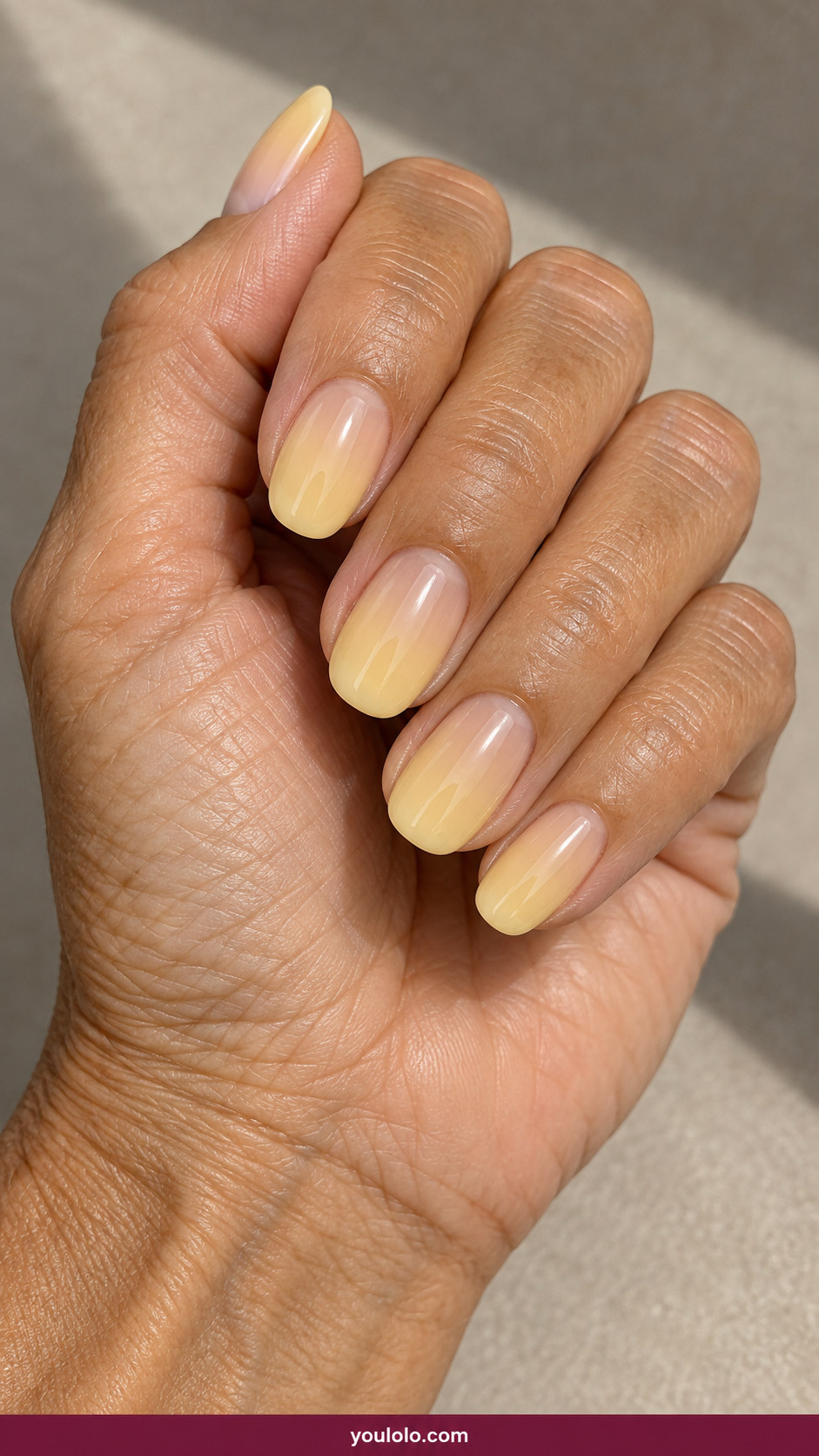 Butter Yellow Nails idea 12: butter-yellow jelly sheer nails with visible natural nail line on an anatomically realistic feminine hand