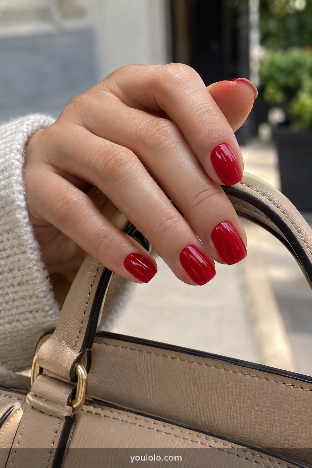 Classic glossy red manicure on practical short nails
