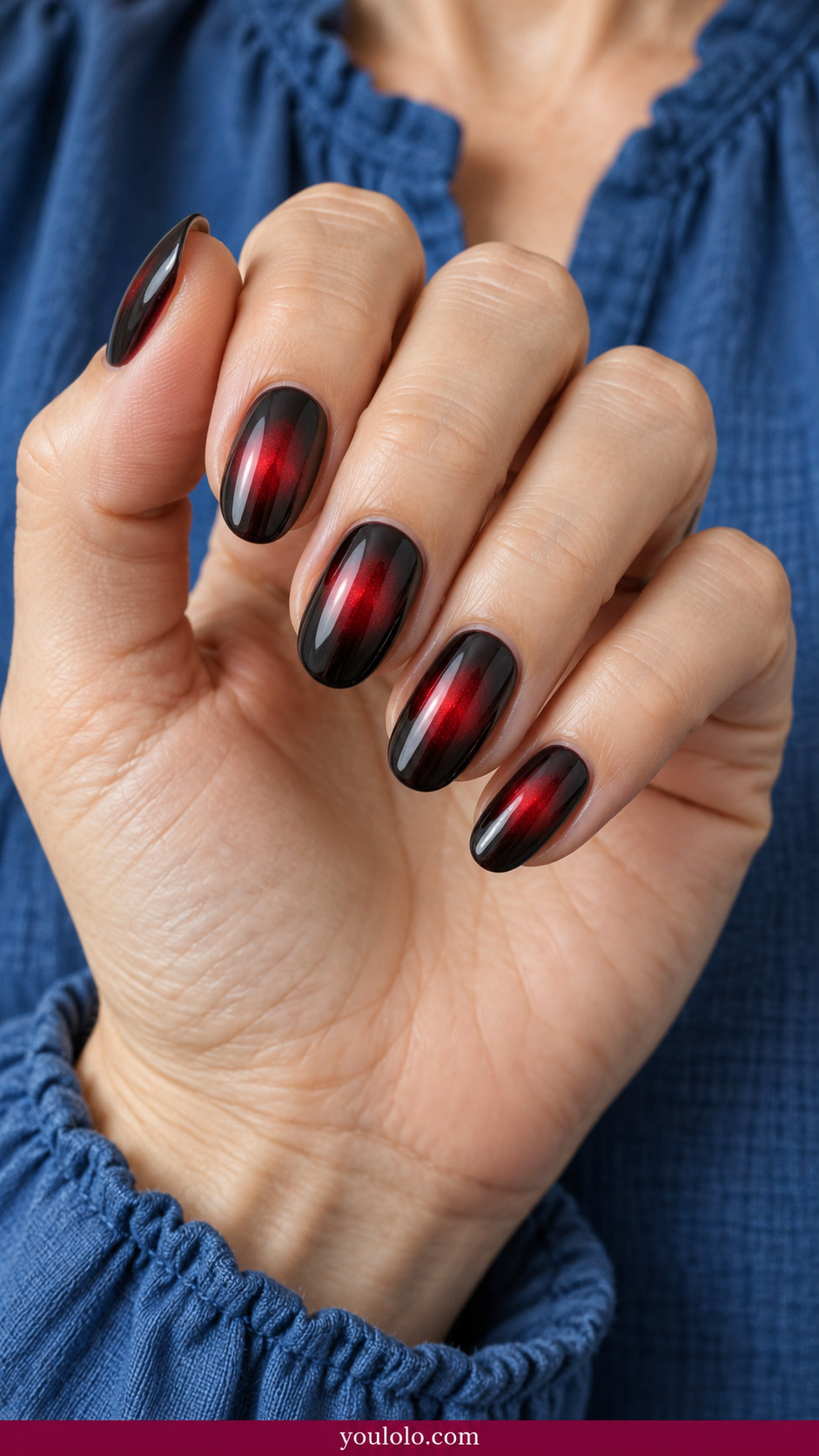 Aura Nails idea 12: dark charcoal nails with a soft cherry-red luminous aura in the middle on an anatomically realistic feminine hand