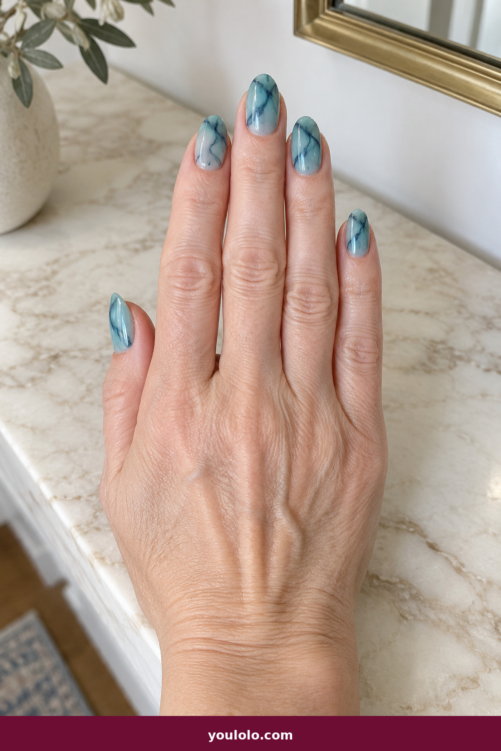 Gel Nails Ideas idea 12: Ocean Ink Marble, medium almond translucent aqua gel with delicate navy ink marbling