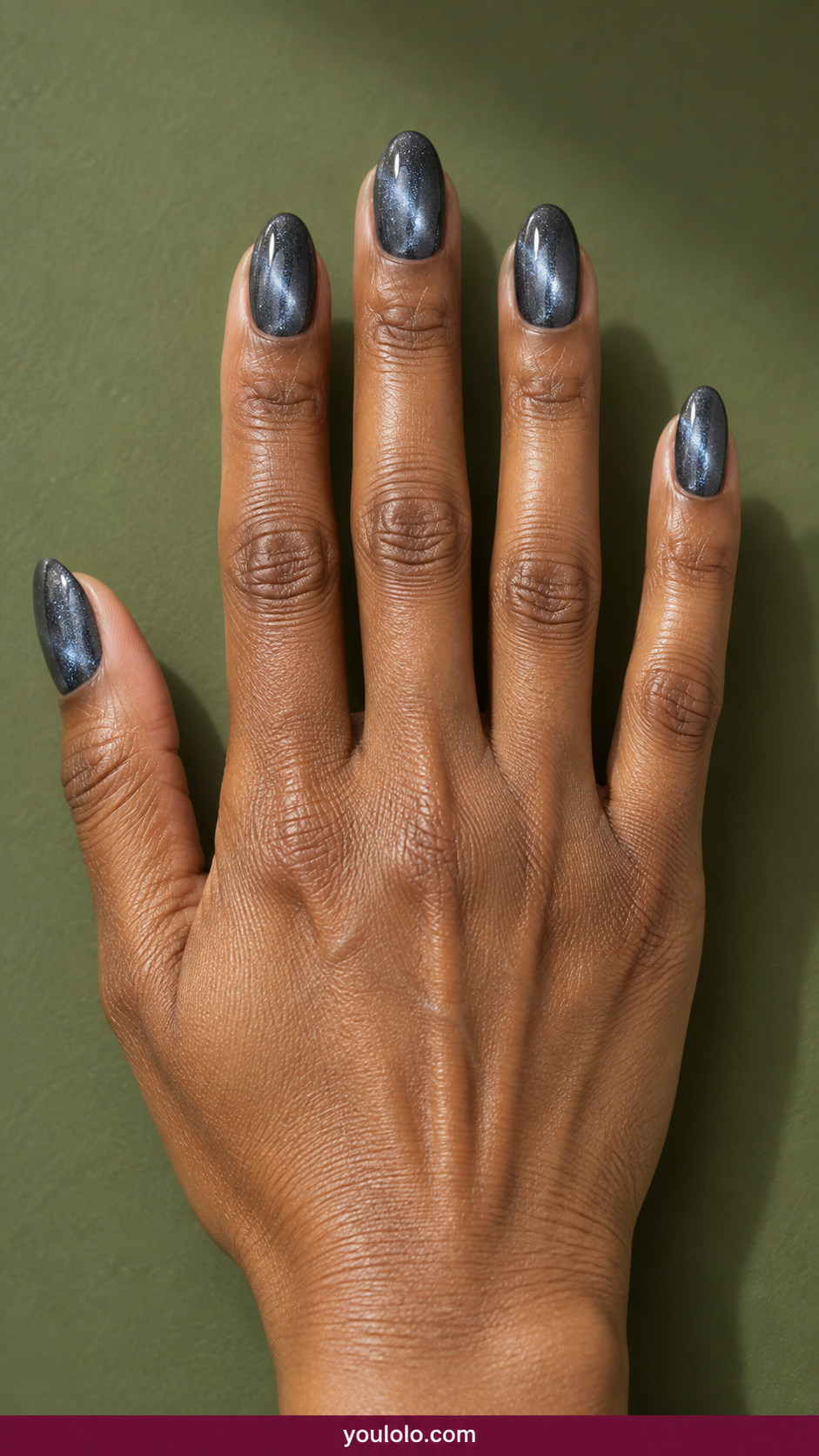 Cat Eye Nails idea 12: slate gray magnetic cat-eye with fine blue-silver shimmer on an anatomically realistic feminine hand
