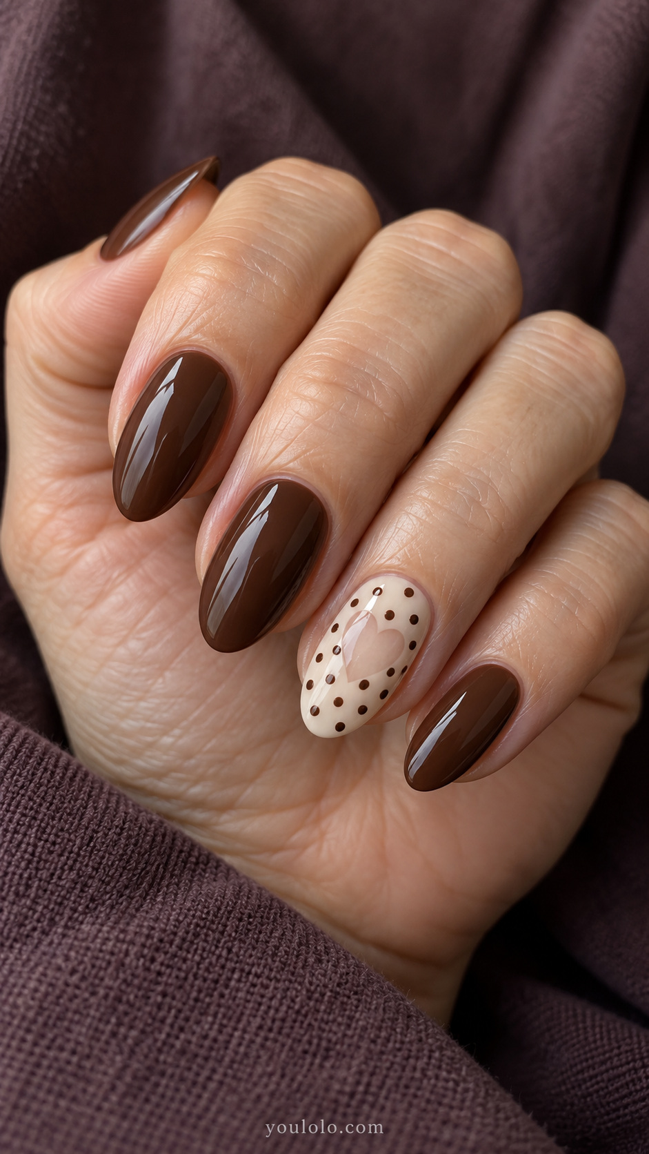 Brown dots around a sheer heart manicure