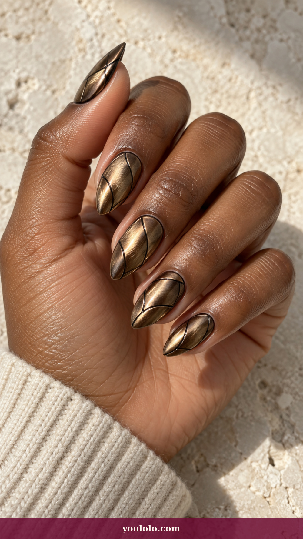 Short Stiletto Nails idea 13: Burnished Bronze Armor on a realistic feminine hand