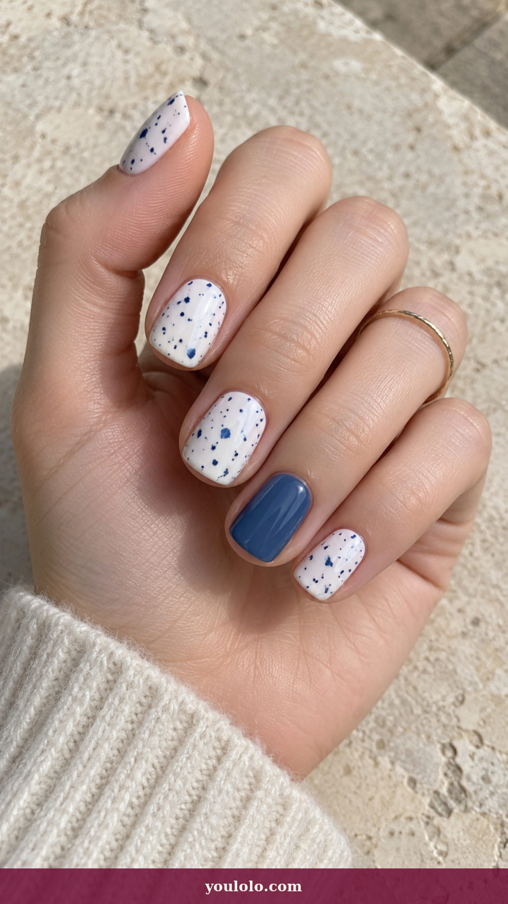 Blue and White Nails idea 13: Indigo Ceramic Speckles on a realistic feminine hand