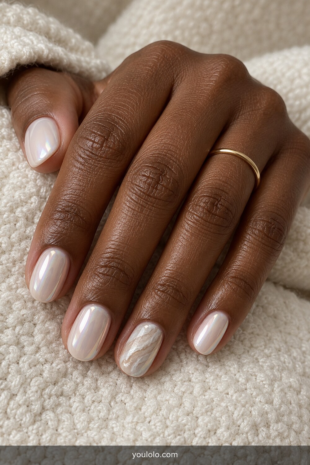 Milky chrome manicure with an oyster shell accent nail