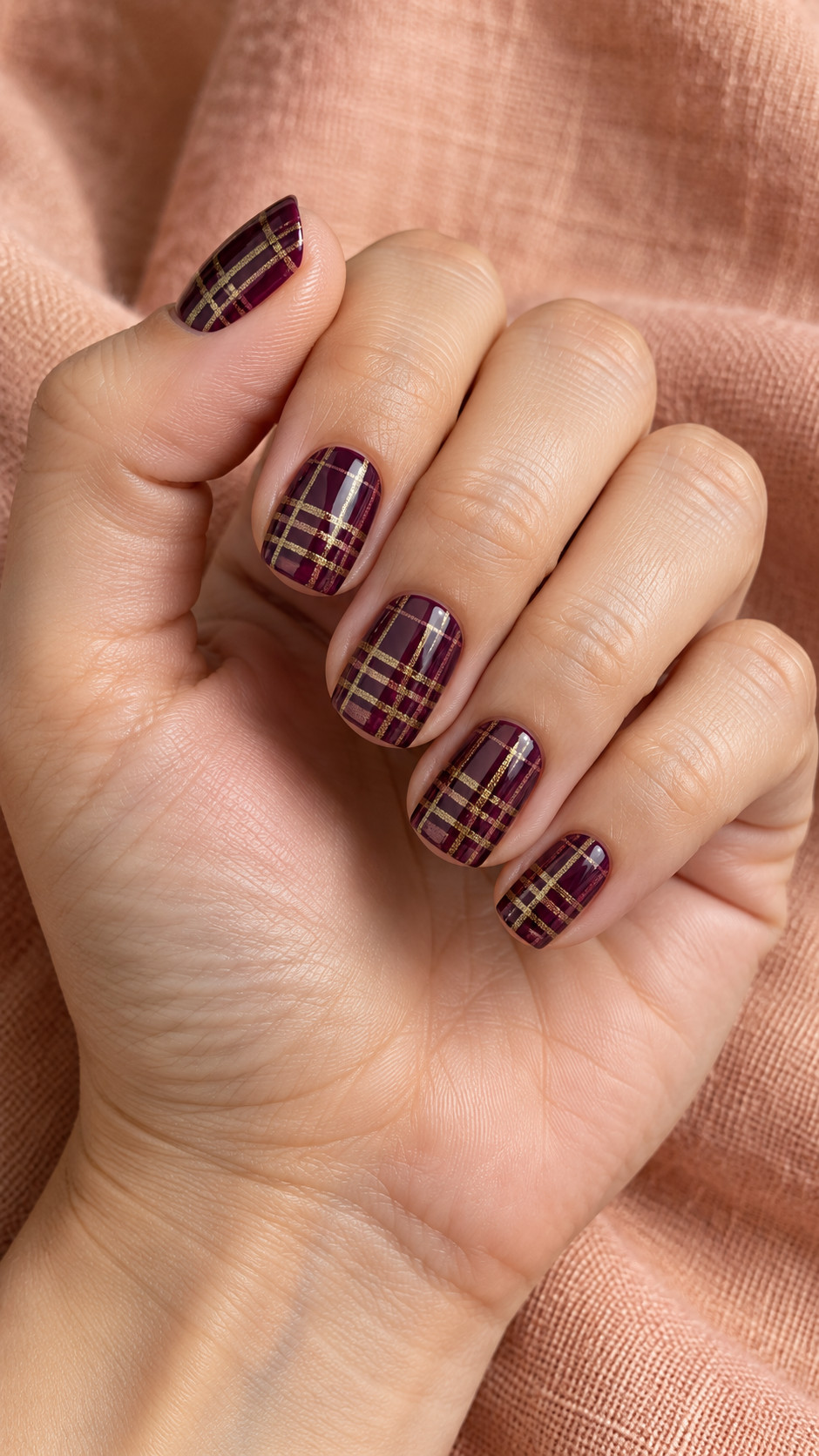 Plaid Nails idea 14: Aubergine and Gold Threads manicure on a realistic feminine hand