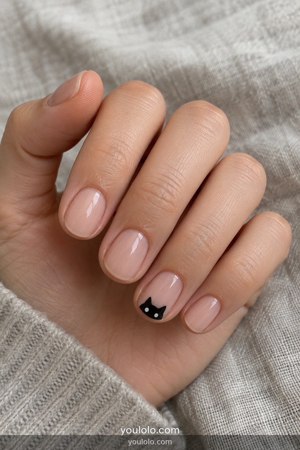 Minimal black cat tip accent on a nude manicure