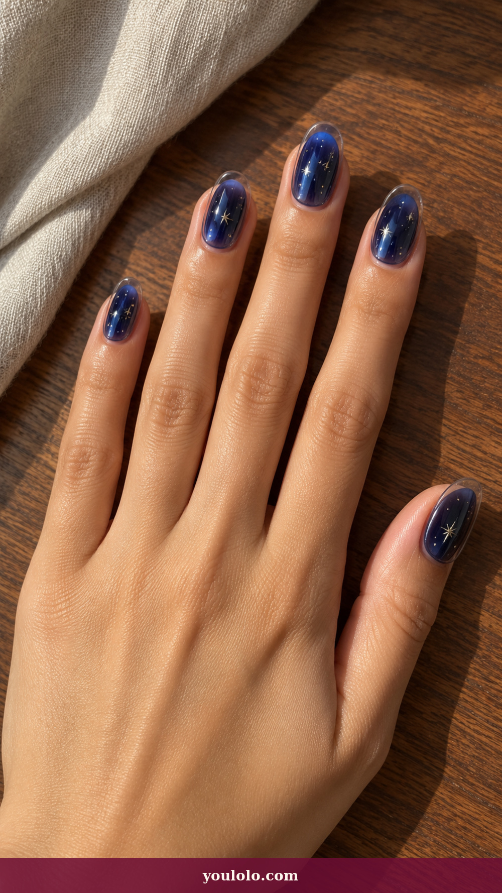 Douyin Nails idea 14: Blue Hour Star Dust on a realistic feminine hand