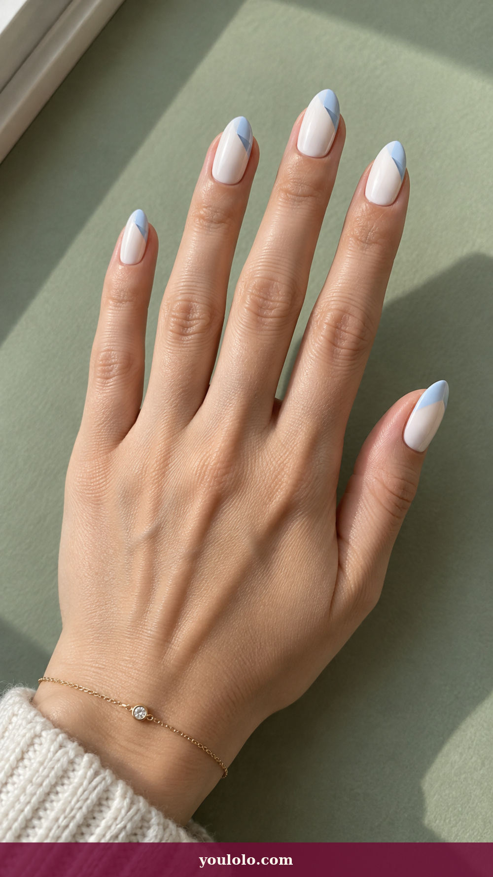 Blue and White Nails idea 14: Powder Blue Fold on a realistic feminine hand