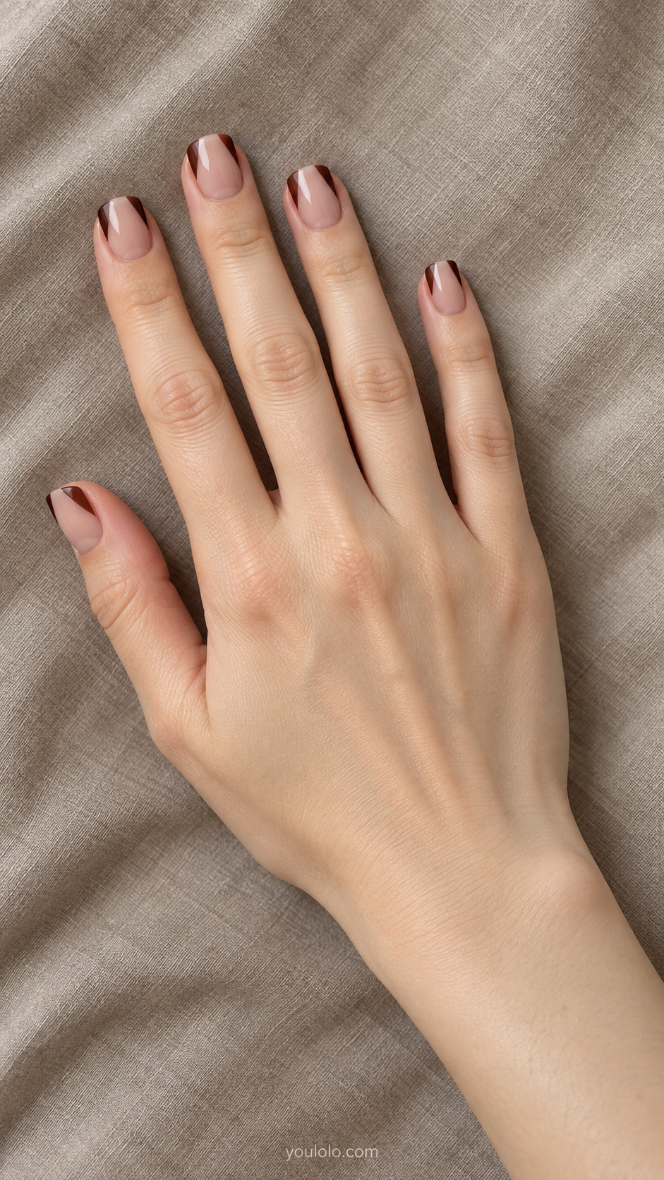 Rounded Corner French — Short squoval nails; warm beige-pink base, chocolate only at the two upper corners, center free edge left nude.
