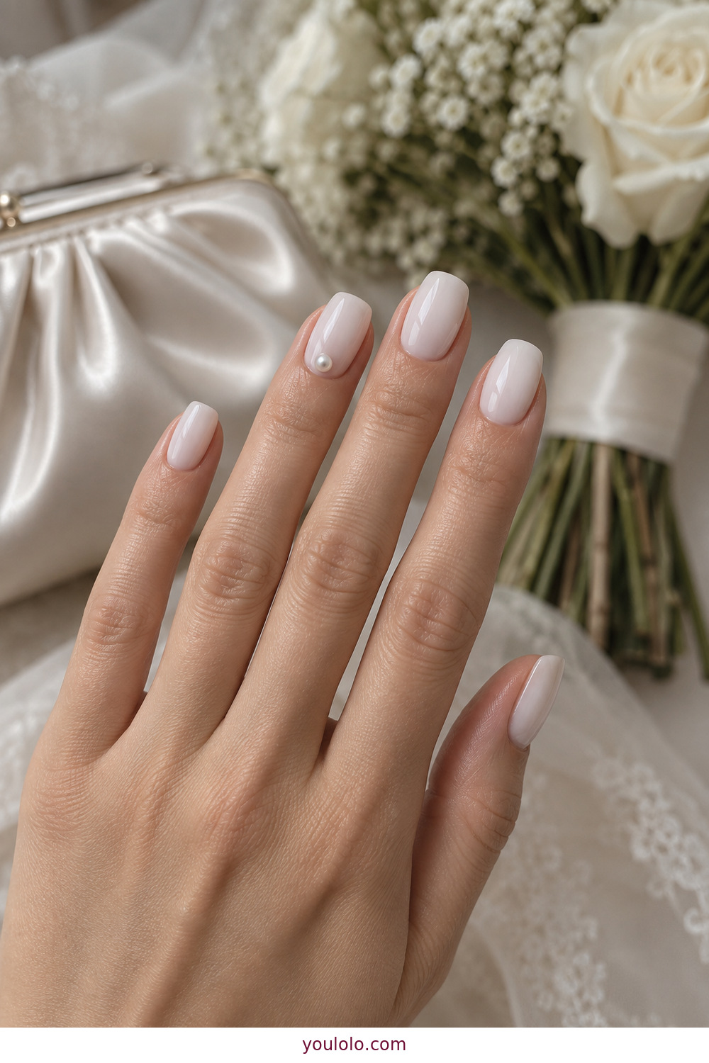 Milky white nails with tiny flat pearl accents