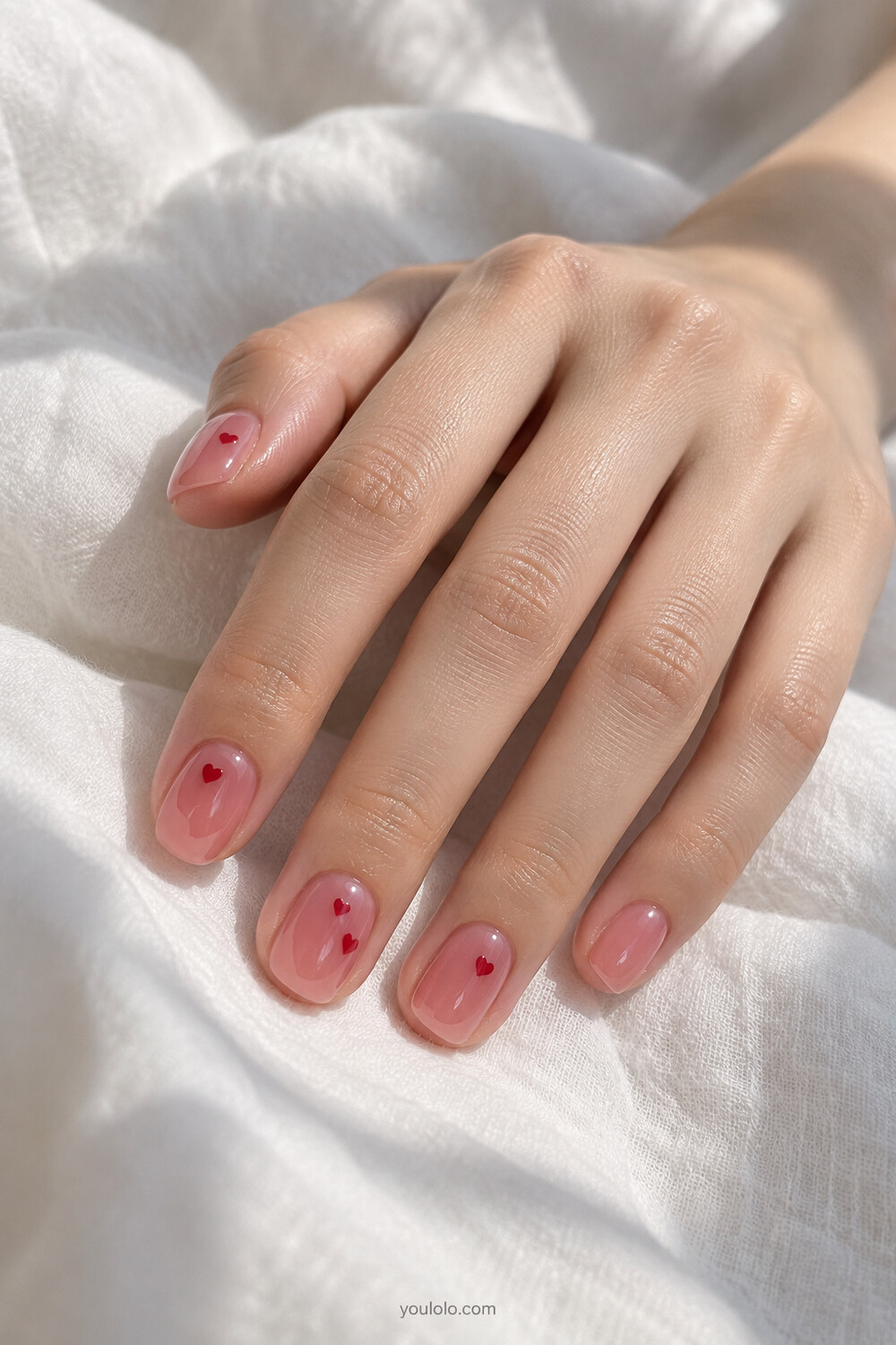 Cherry pink jelly manicure with tiny encapsulated red heart confetti