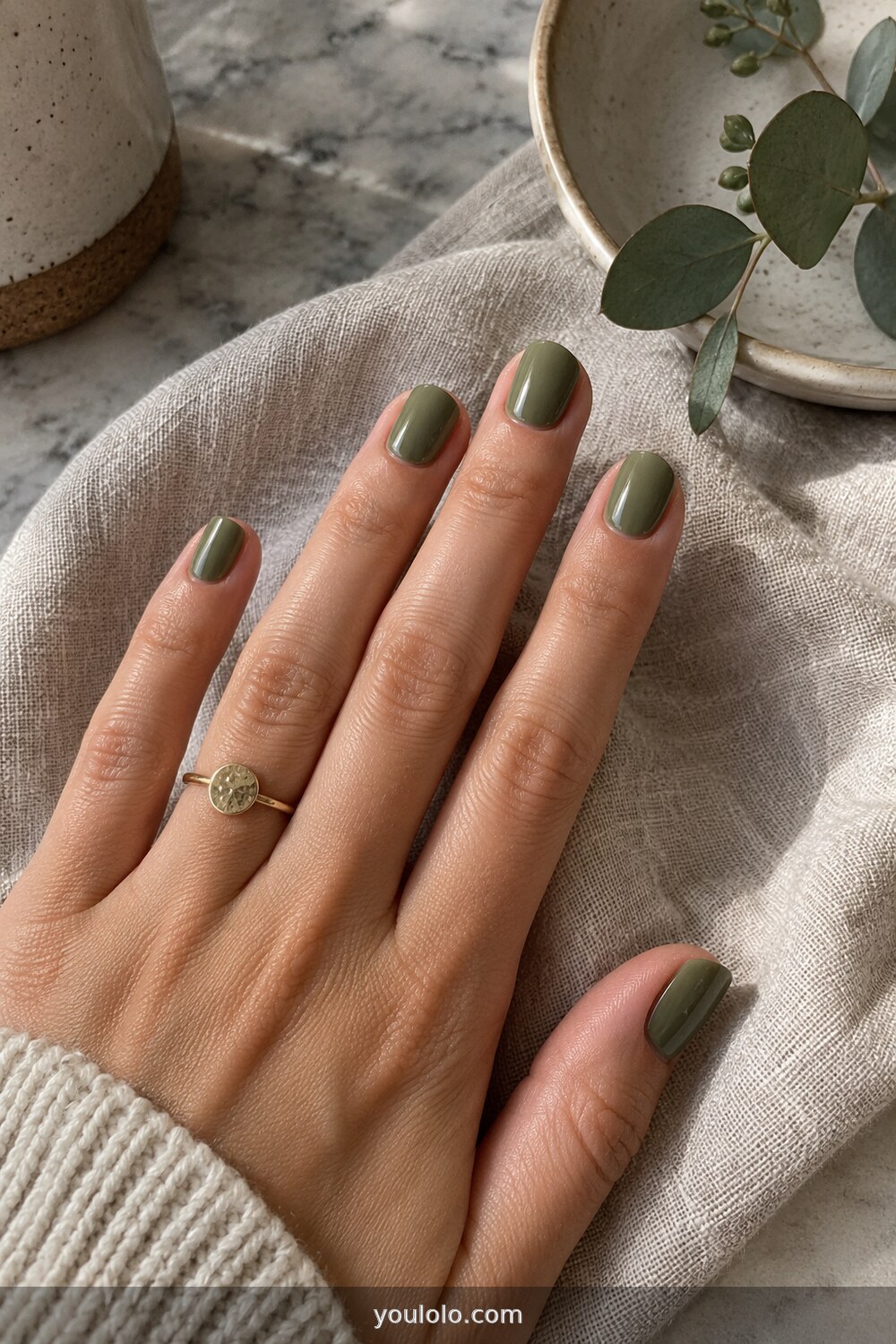 Muted olive green cream polish on short nails