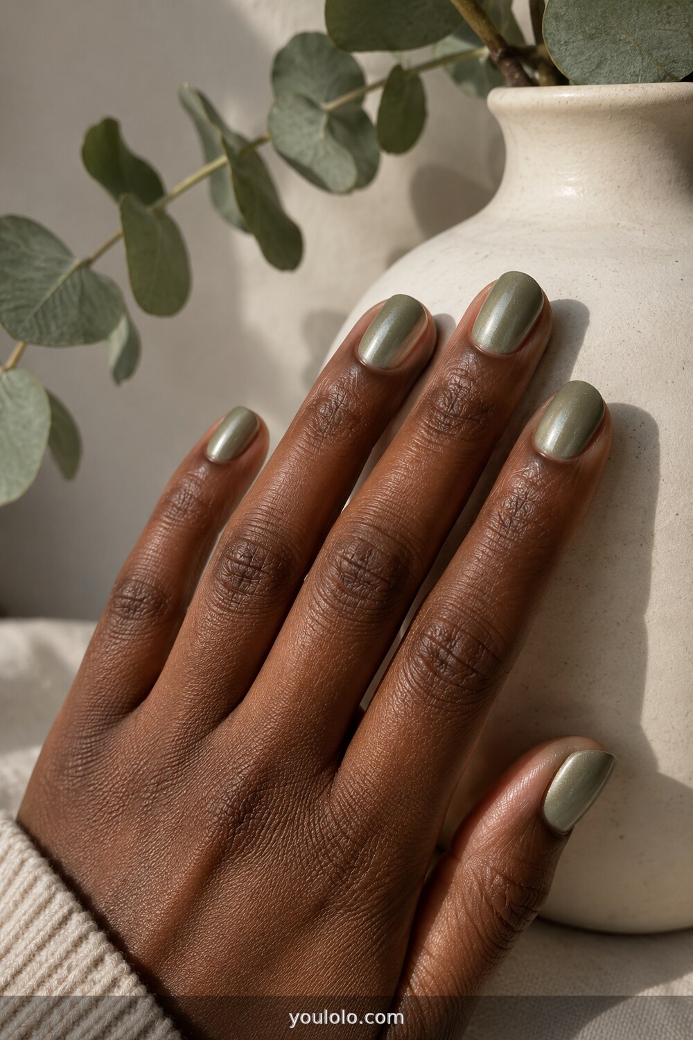 Muted sage nails with a soft chrome glow