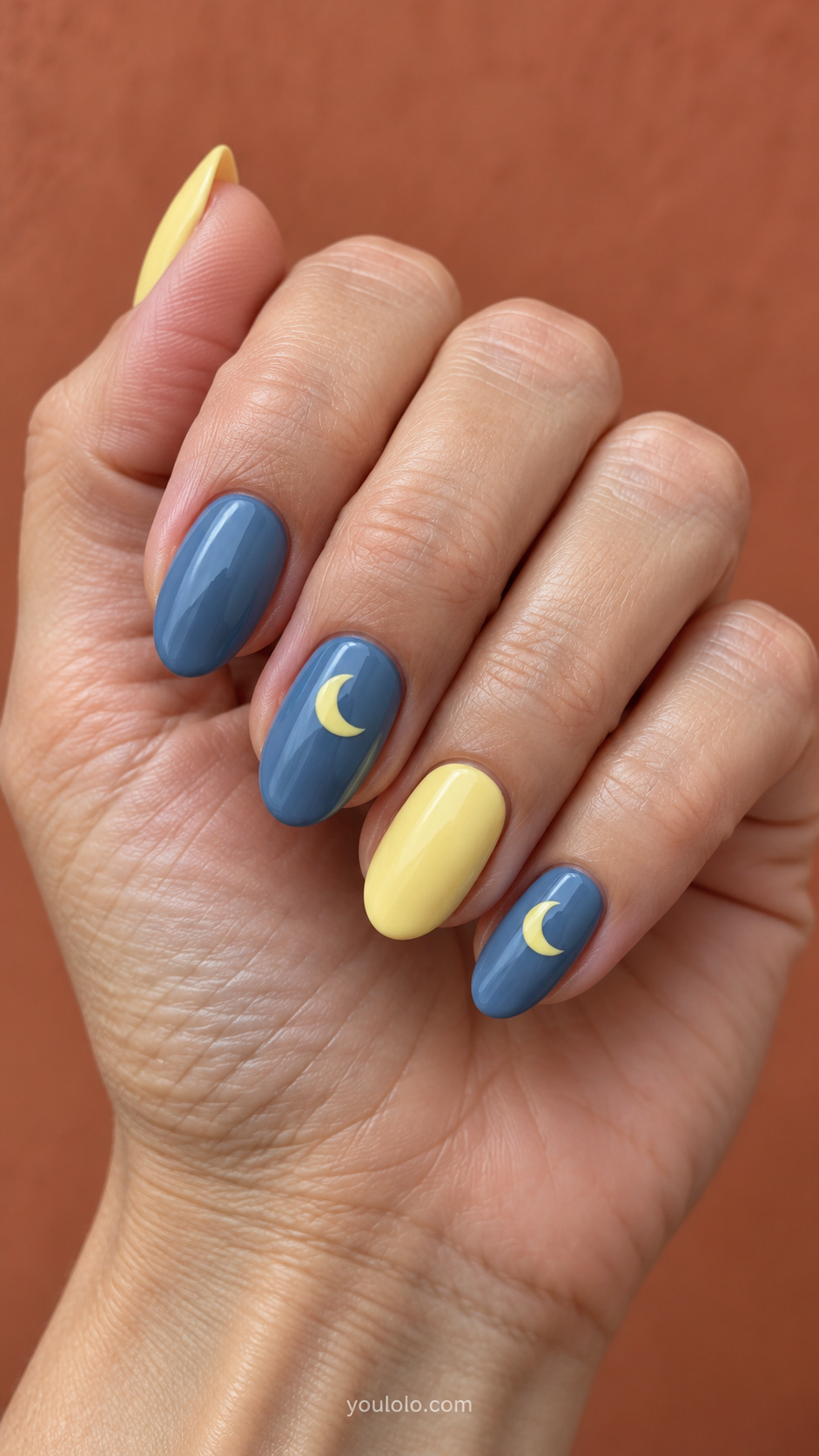 Yellow crescents on muted blue manicure