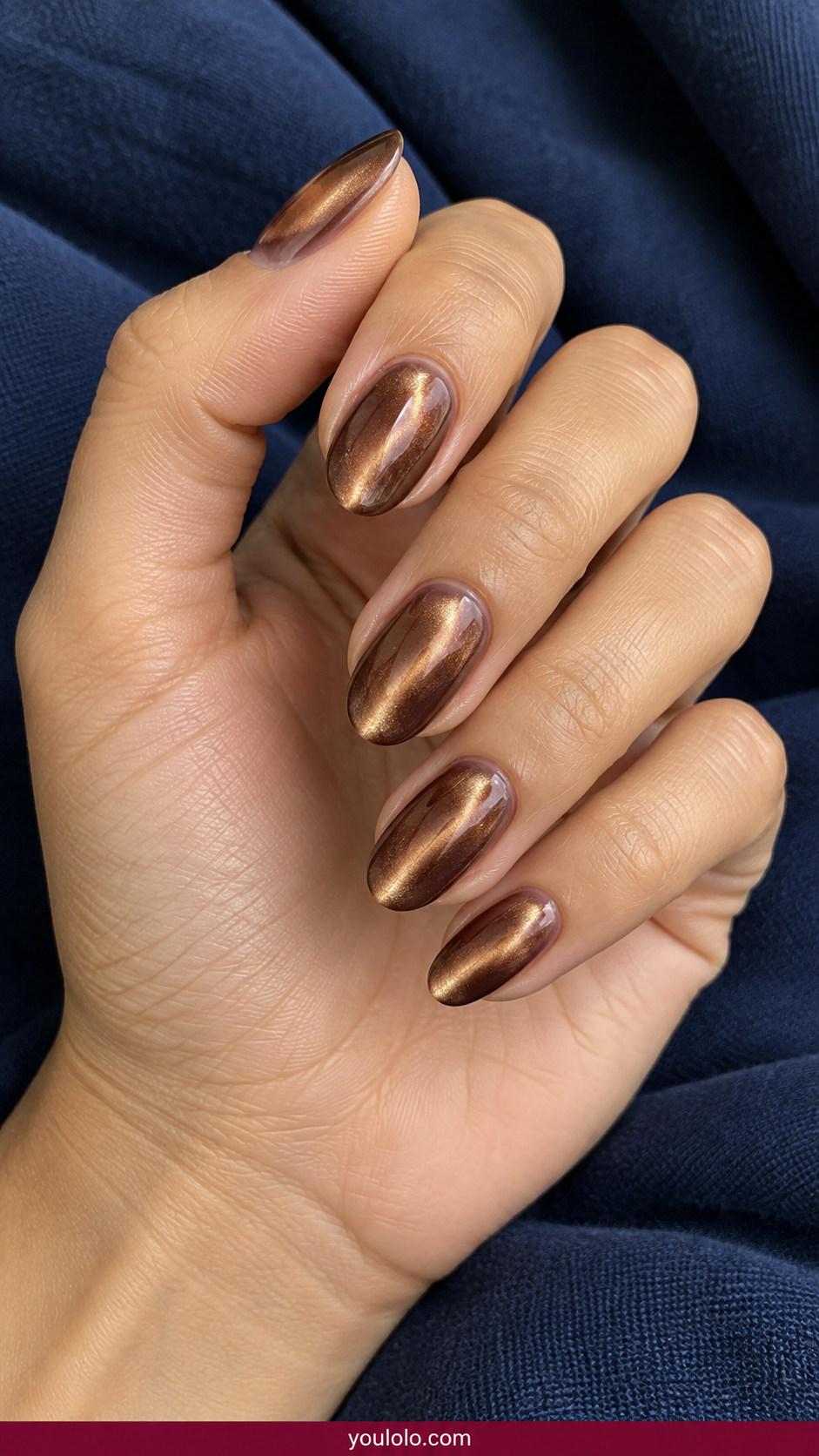 Cat Eye Nails idea 16: bronze cat-eye gradient with centered reflective stripe and sheer base on an anatomically realistic feminine hand