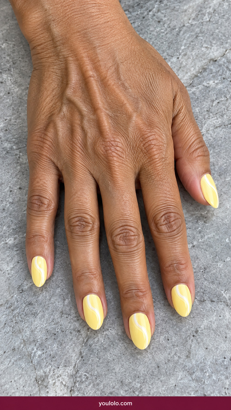 Butter Yellow Nails idea 16: butter-yellow nails with thin ivory wavy ribbon accent on an anatomically realistic feminine hand