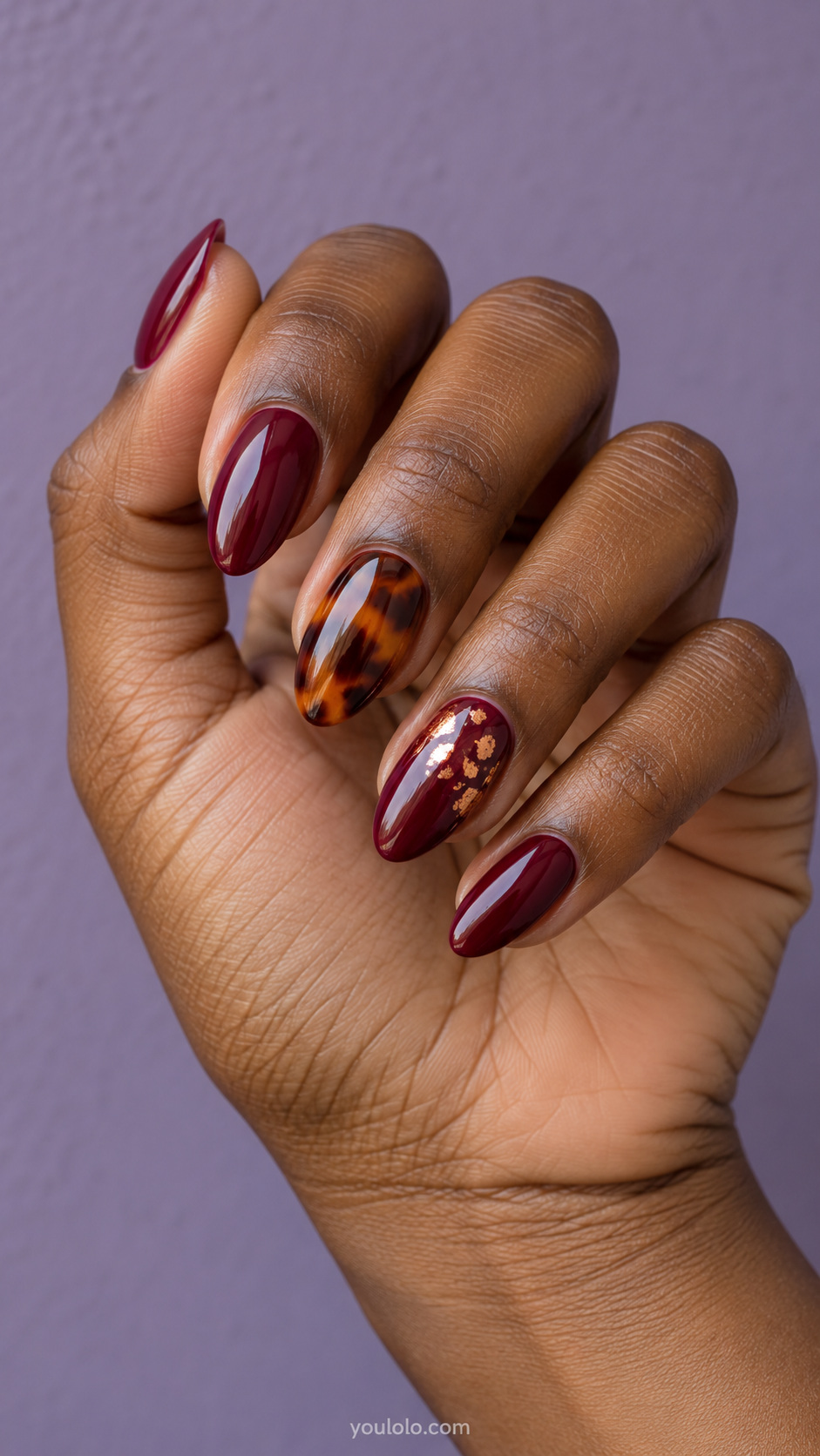 Copper flecks over a wine-and-amber set manicure