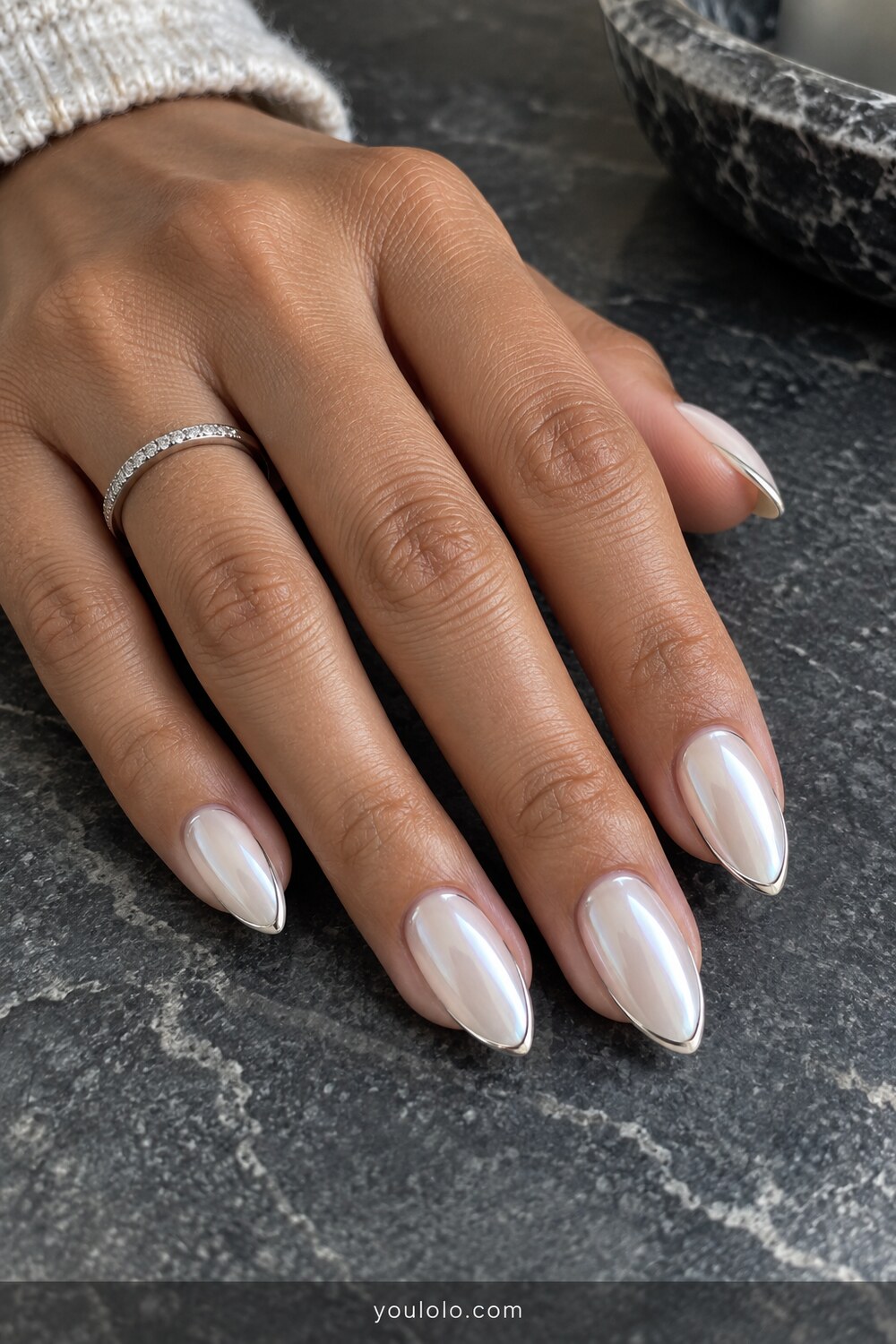 Milky pearl almond nails with a fine silver outline