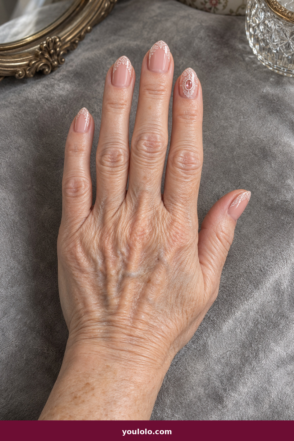 Pink Nails with Rhinestones on One Finger Ideas: Pink Lace Cameo, Dusty-pink oval nails with ivory lace linework and one oval rose-crystal cameo on the ring finger.