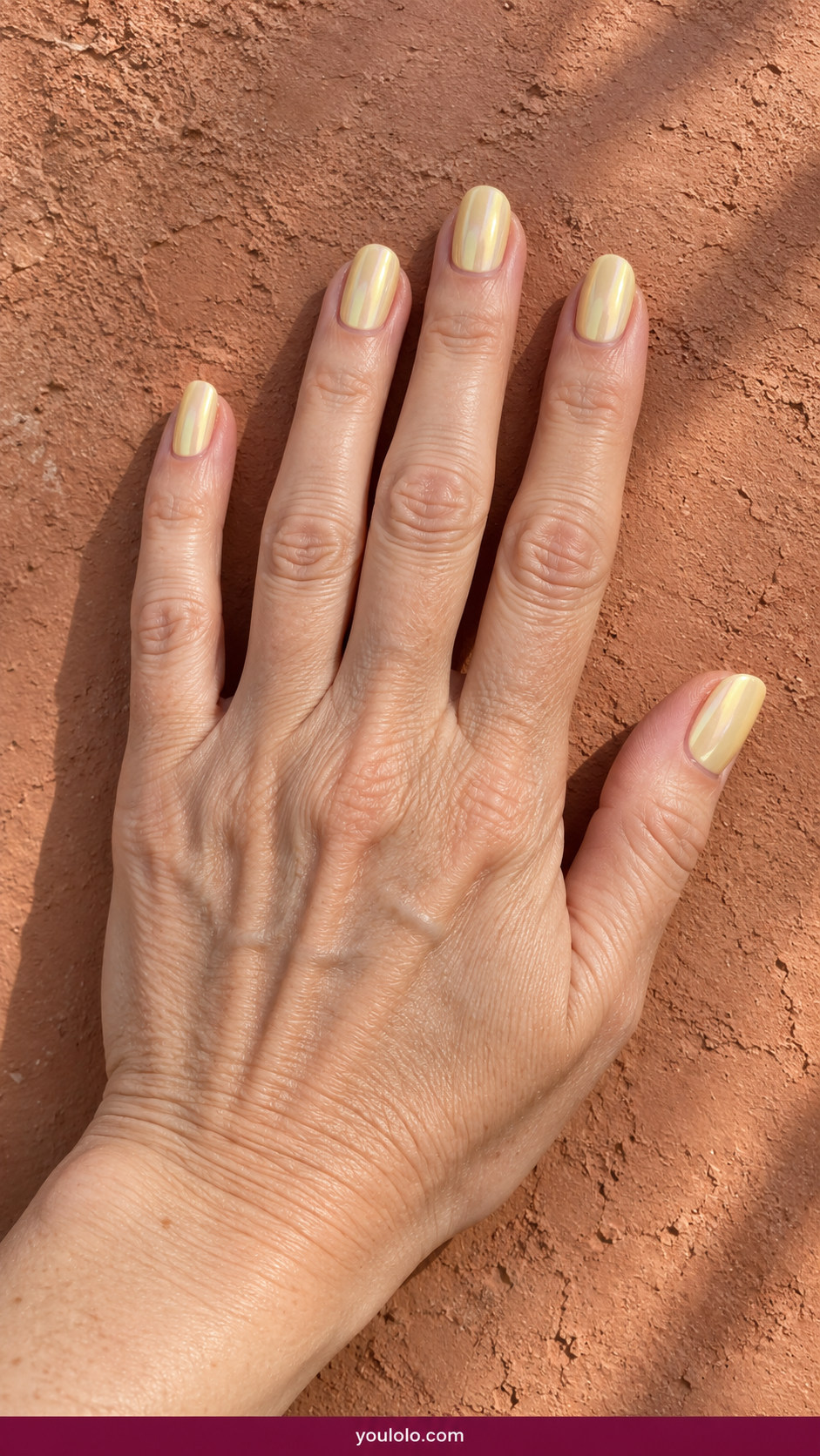 Butter Yellow Nails idea 17: butter-yellow chrome glaze subtle pearly reflective finish on an anatomically realistic feminine hand