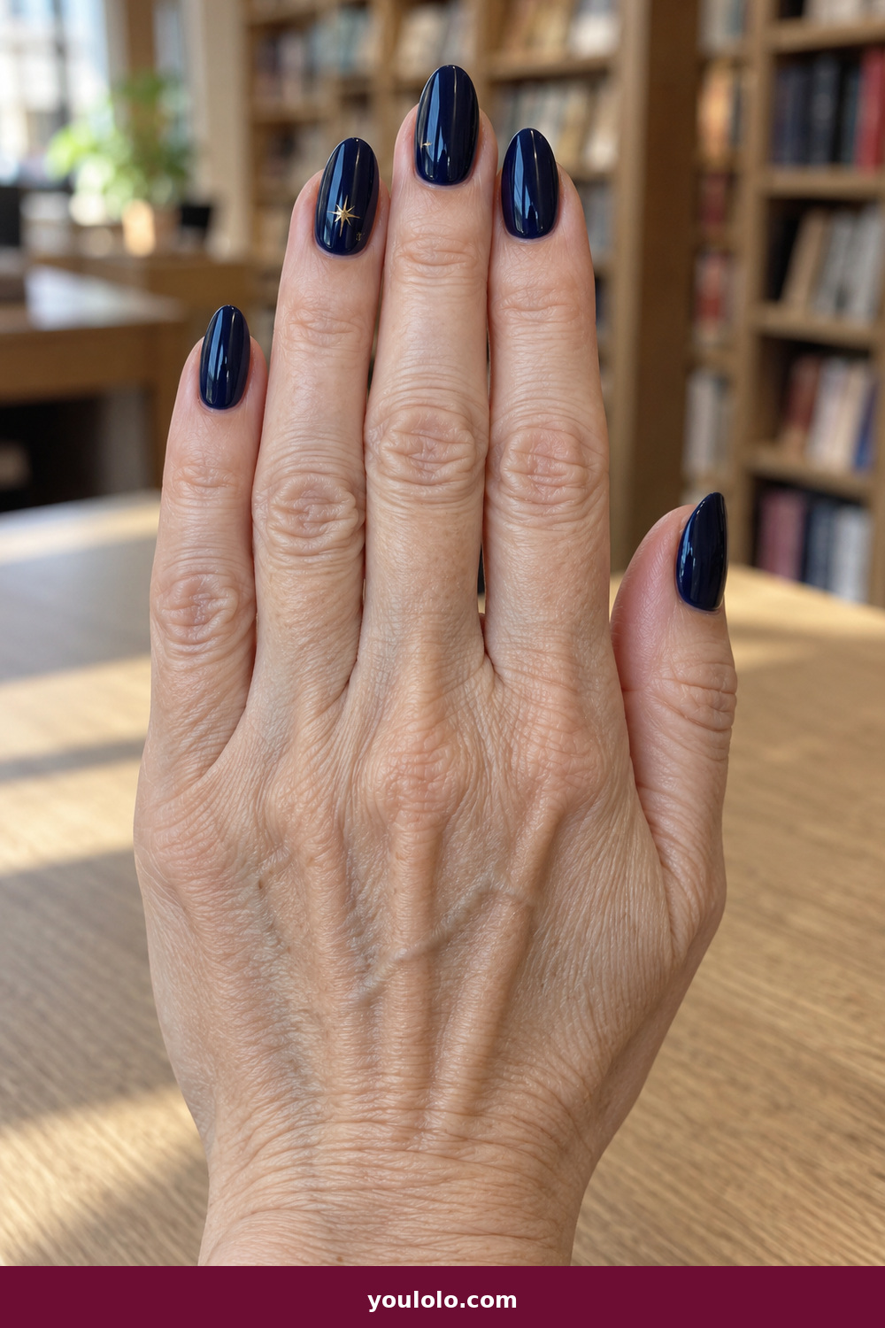 Elegant Almond Nails idea 17: Midnight Star Pin, medium almond midnight navy nails with one tiny gold star pin per hand