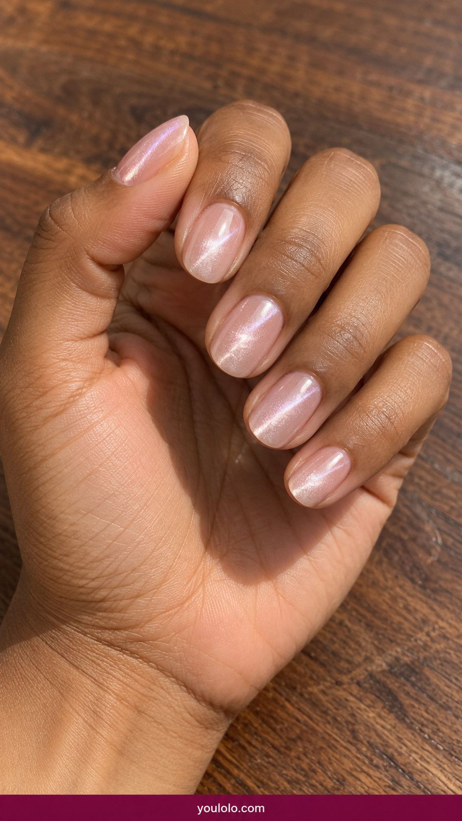 Cat Eye Nails idea 17: short oval milky pink cat-eye with a faint luminous pearl line on an anatomically realistic feminine hand
