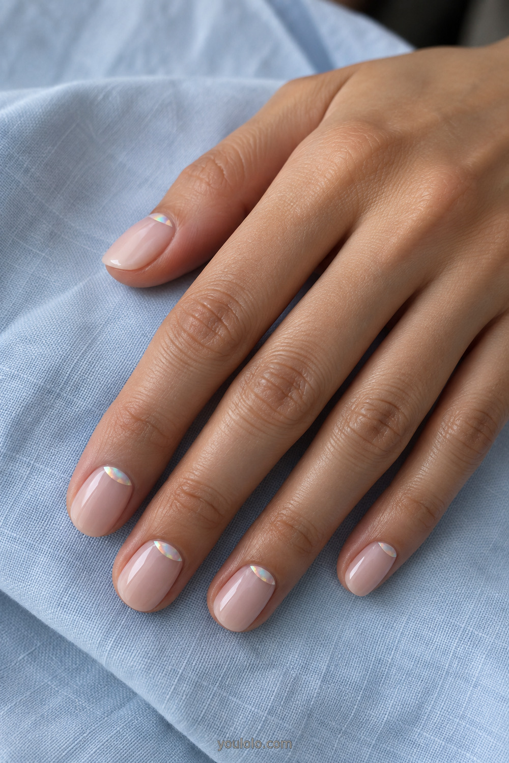 Short nude nails with iridescent chrome crescents at the cuticles