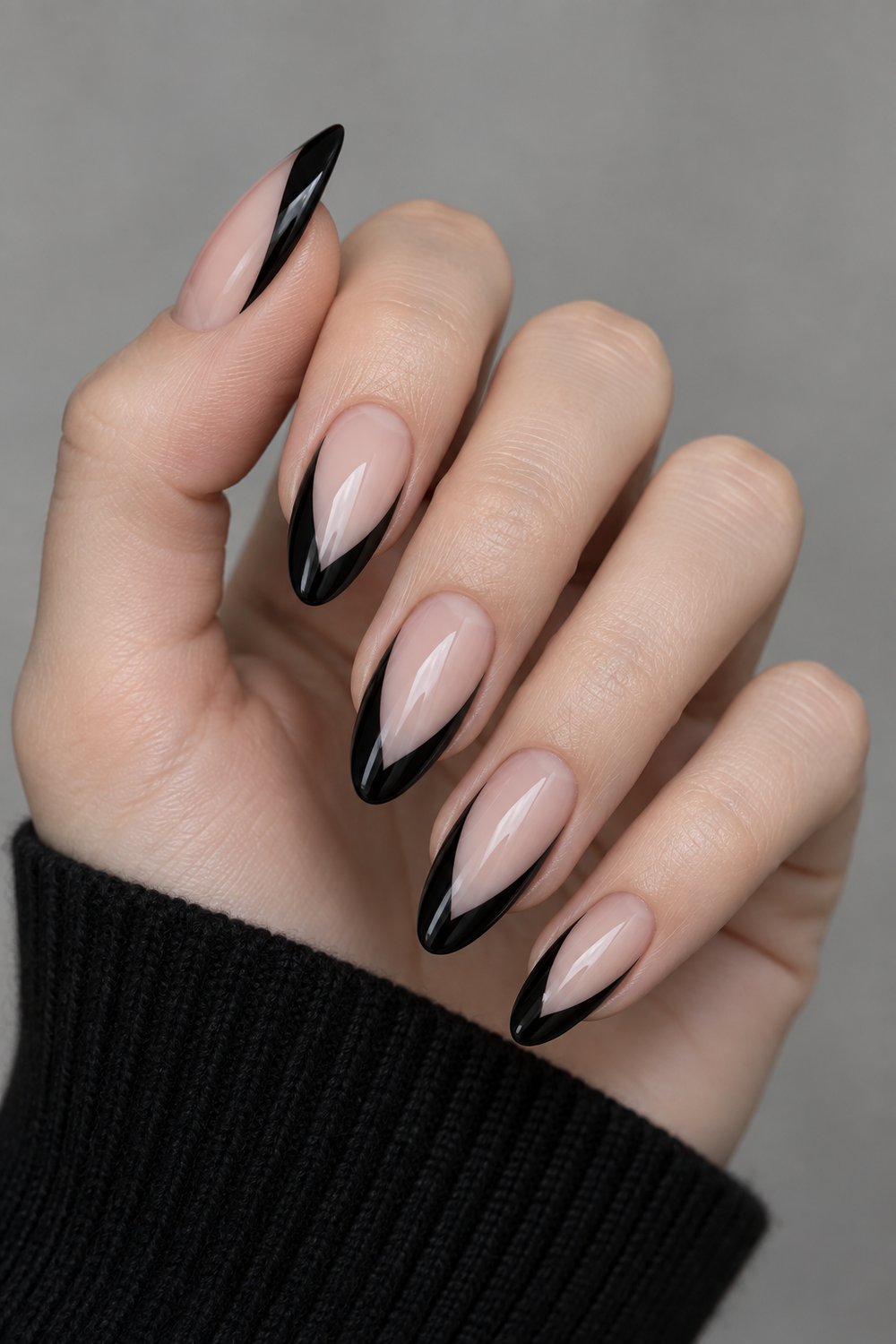 Curved black French tips that elongate almond nails