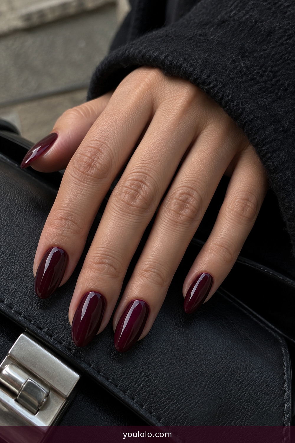 Deep black raspberry wine manicure in daylight