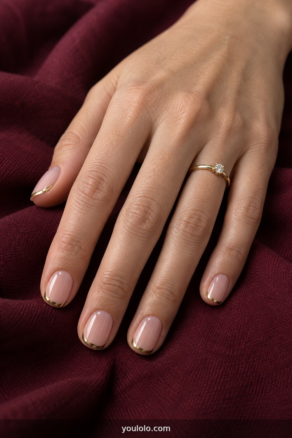 Thin gold micro French tips over a sheer pink base