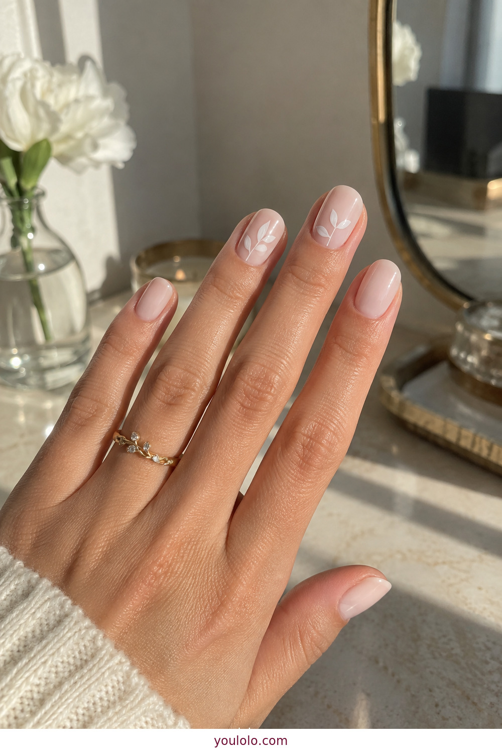 Fine white botanical sprigs painted on milky nude nails