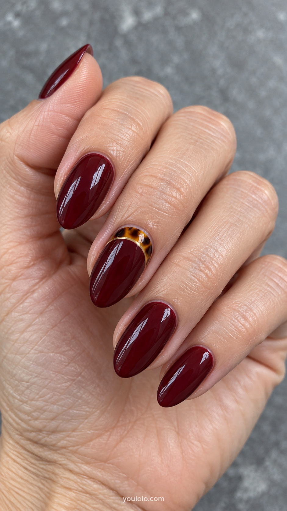 Burgundy with a thin amber cuticle cuff manicure