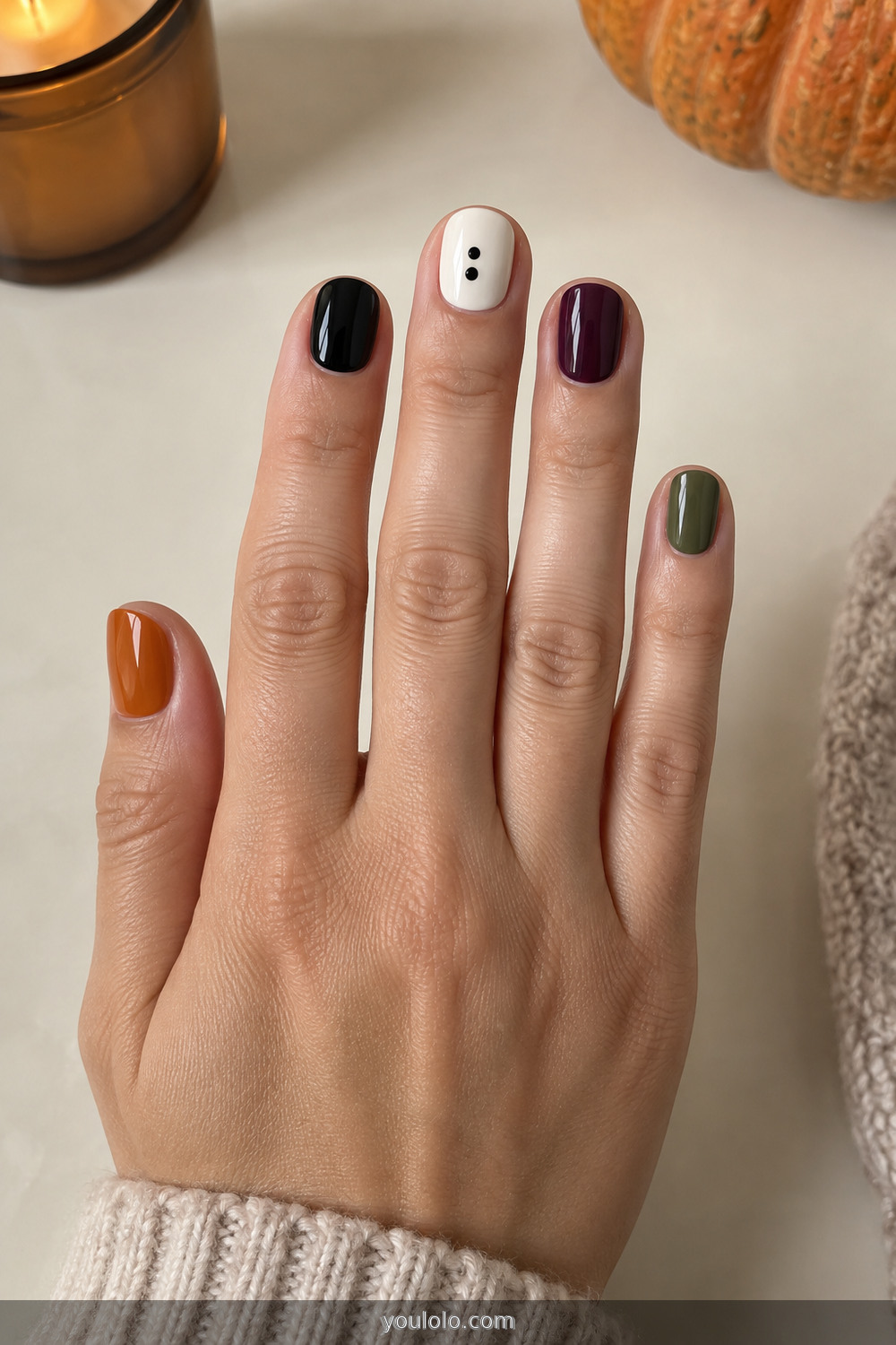 Halloween color skittle manicure in orange black plum and olive