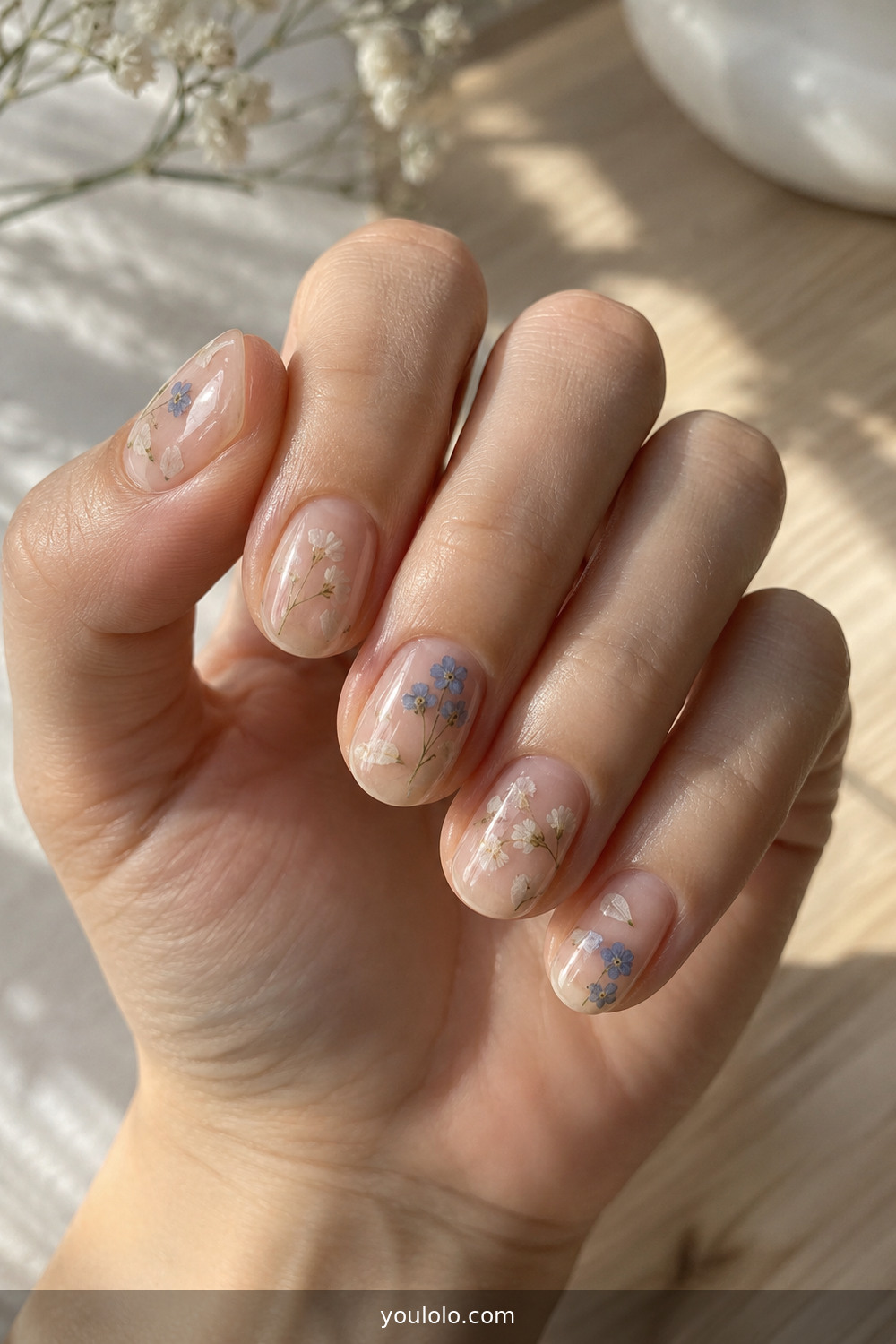 Clear gel manicure with tiny dried flowers