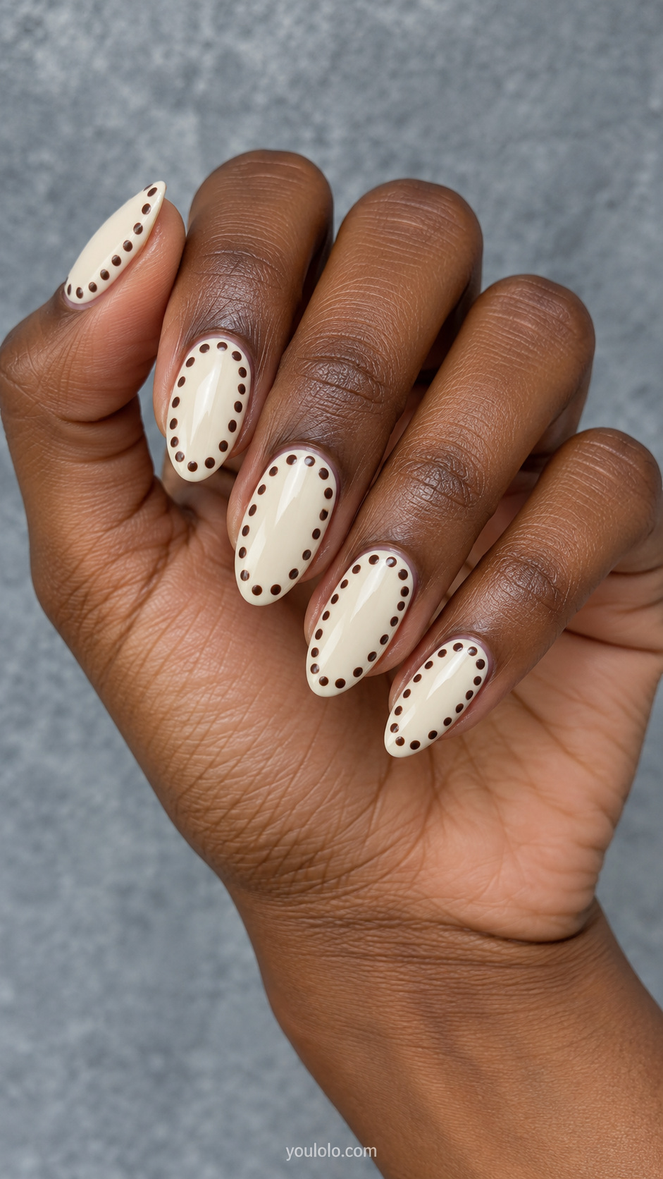 A dotted border around cream centers manicure