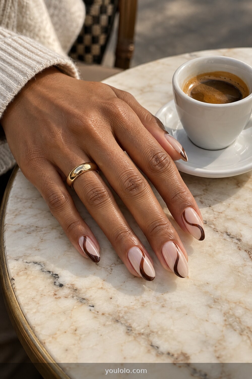 Espresso brown swirl nail art over a cream base