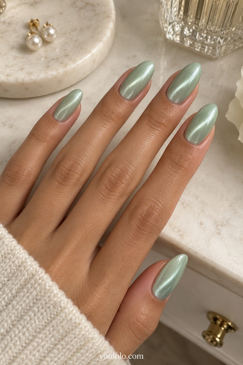 Long mint green almond nails with layered stone details