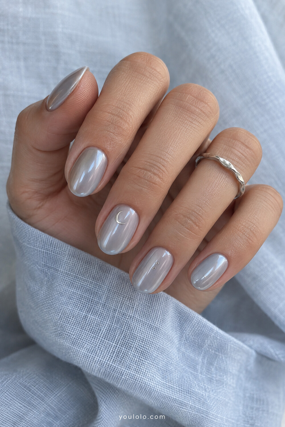 Dove grey moonlight chrome nails with a tiny crescent accent