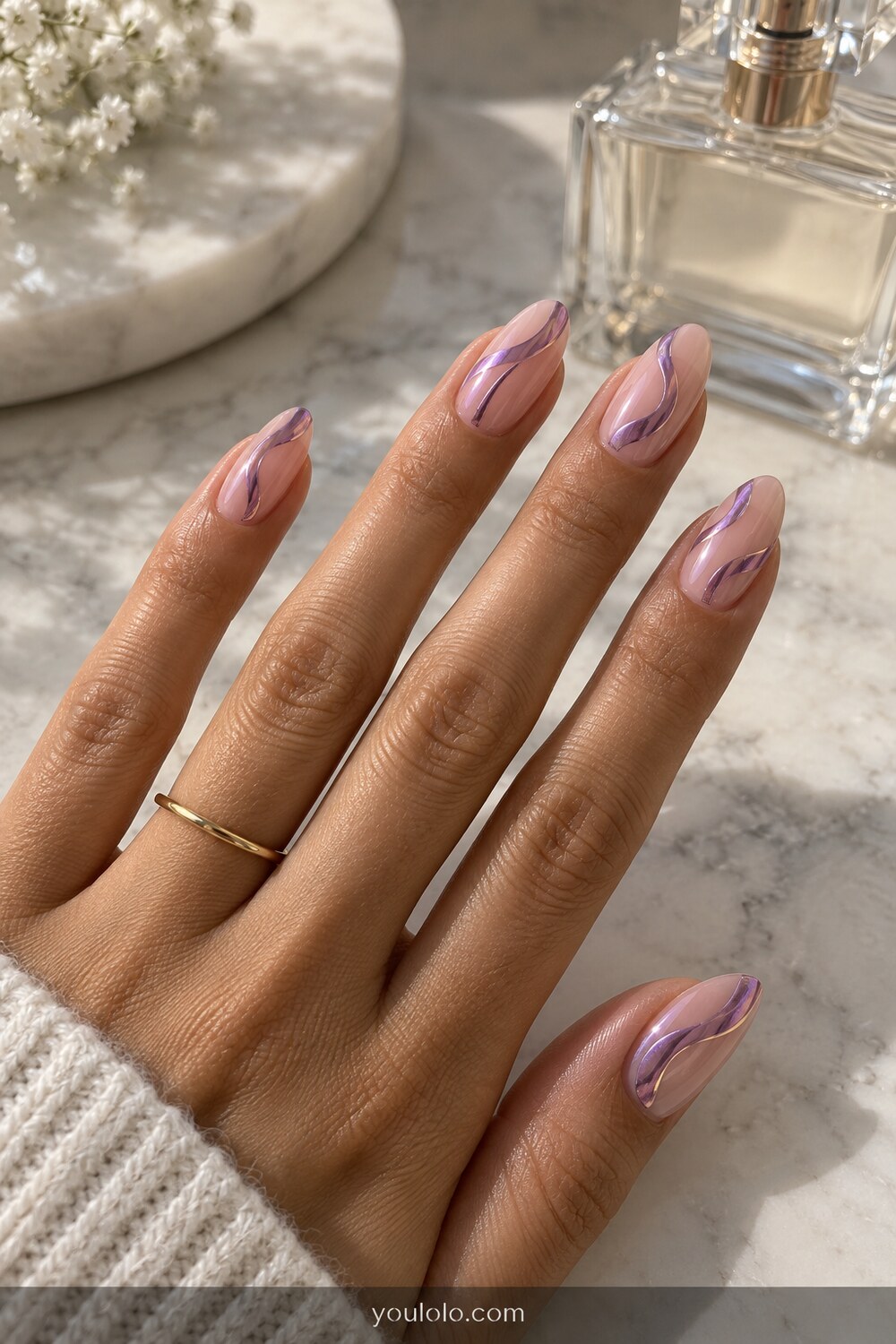 Sheer nude almond nails with flowing orchid chrome swirls