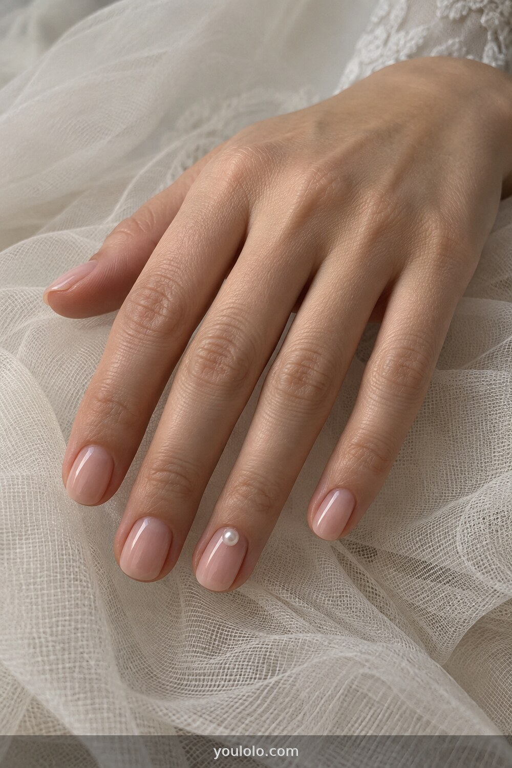 Sheer blush nails with one tiny pearl accent