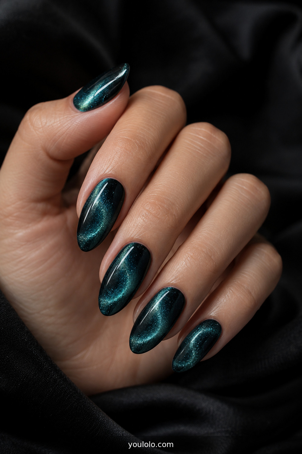 Deep teal magnetic cat-eye nails with orbit glow