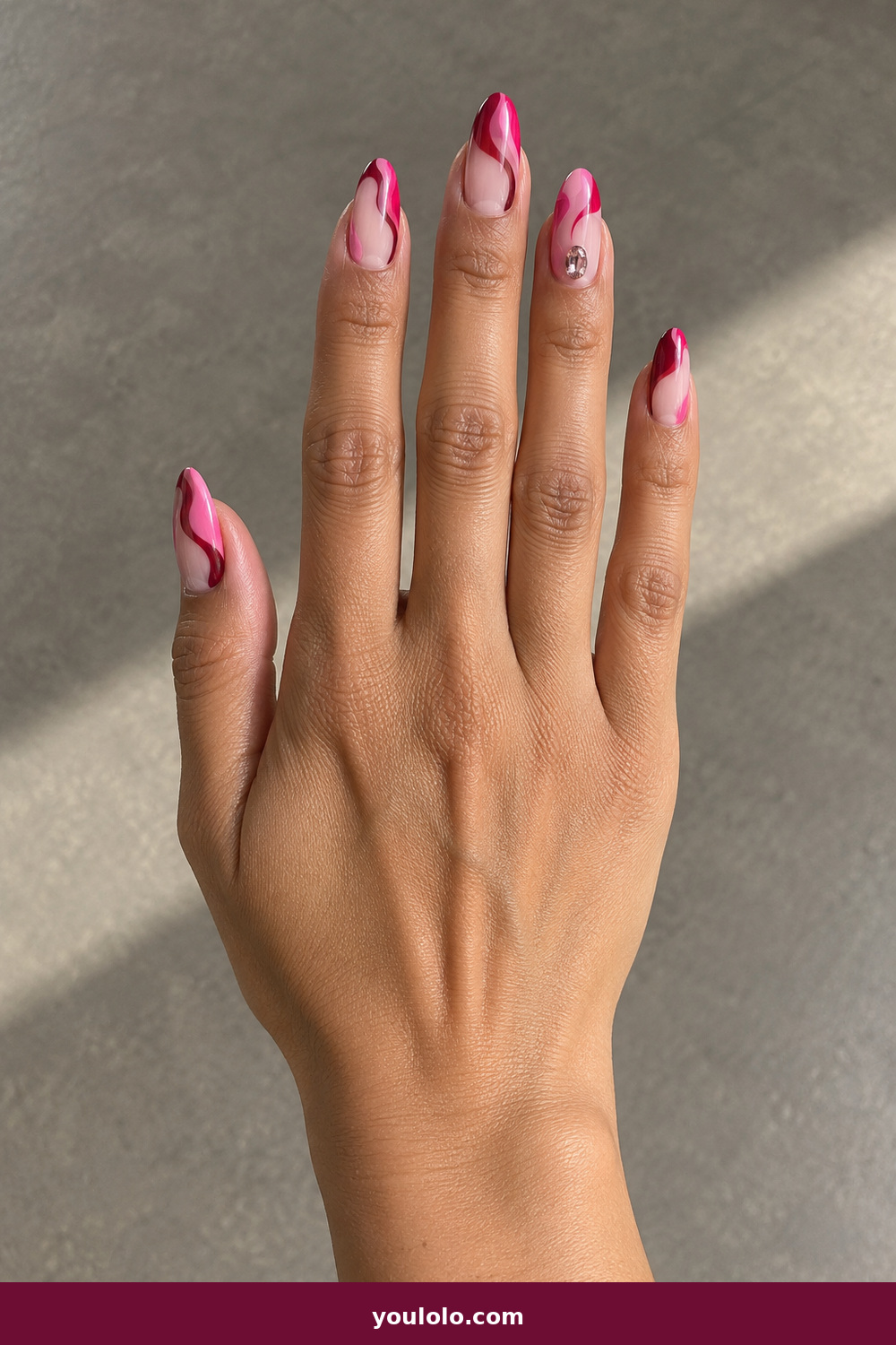 Pink Nails with Rhinestones on One Finger Ideas: Editorial Hot-Pink Swirl Jewel, Almond nails with hot-pink, wine and blush fluid swirls, finished with one oval crystal on the ring finger.