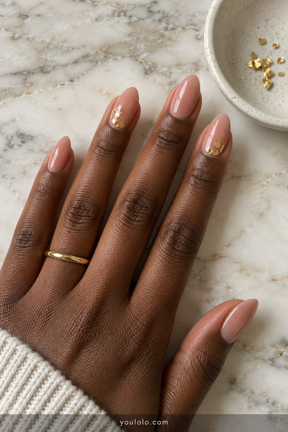 Nude almond nails with restrained antique gold flakes