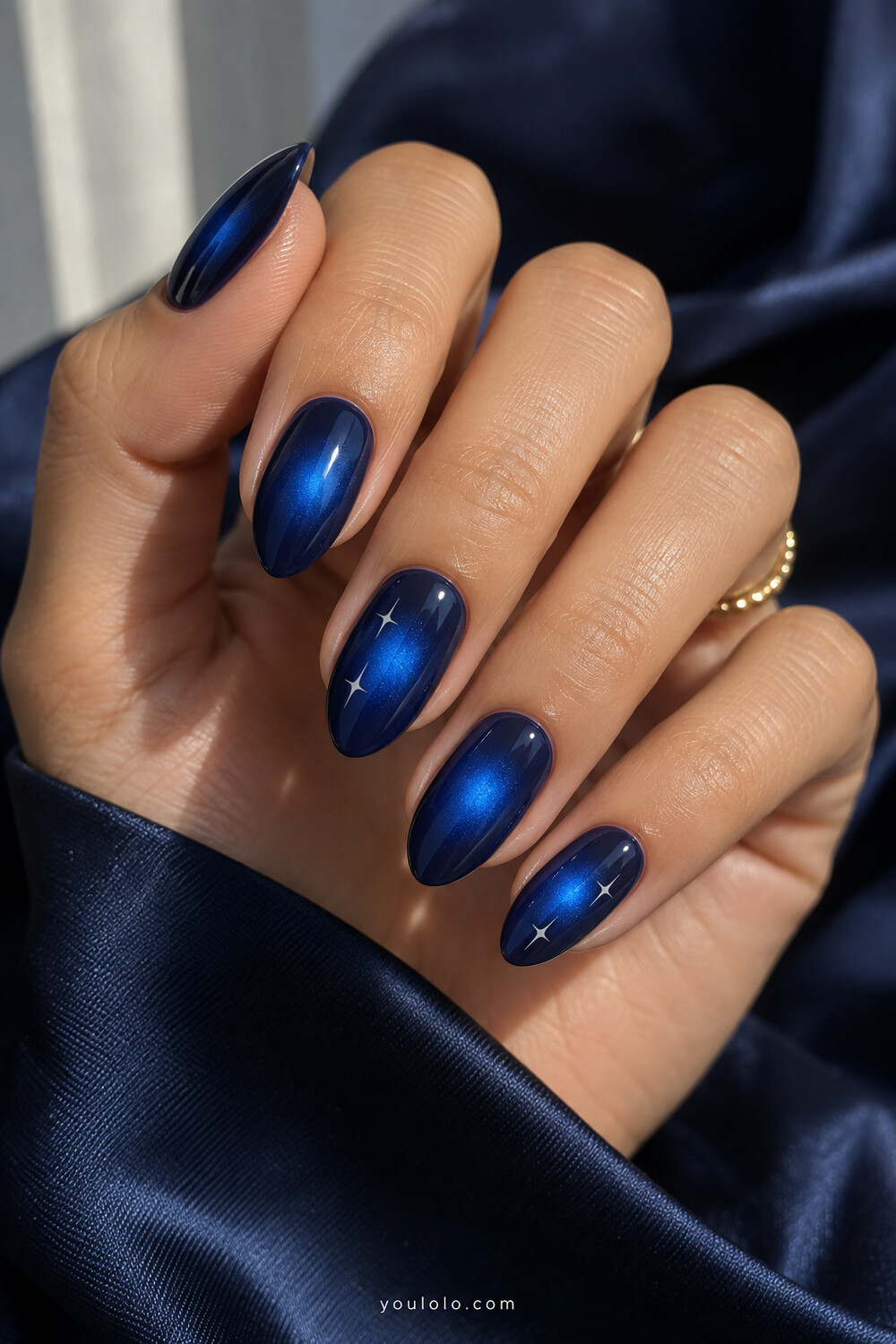 Indigo almond nails with cobalt aura centers and crisp white stars